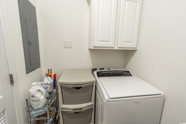 laundry room with cabinet space, electric panel, and separate washer and dryer