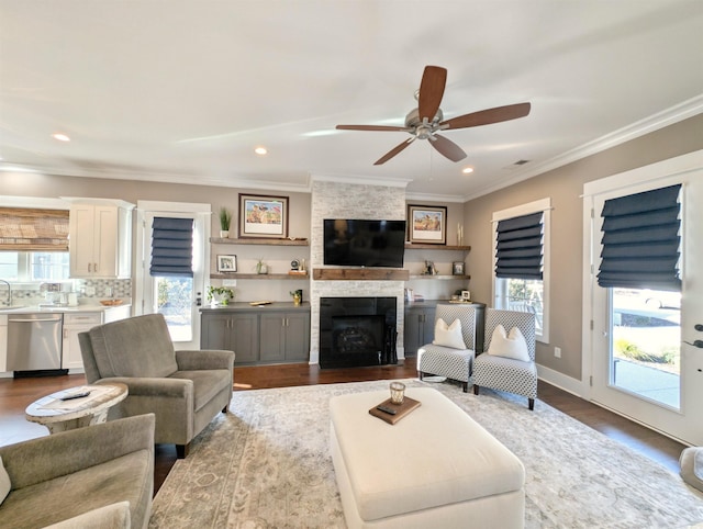 living room with crown molding, a fireplace, light wood finished floors, recessed lighting, and baseboards