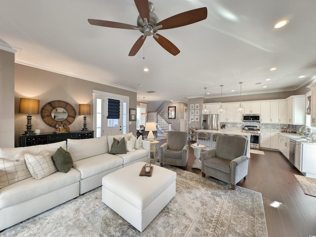 living area featuring crown molding, stairway, recessed lighting, and light wood-style floors