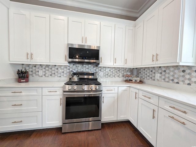 kitchen featuring stainless steel appliances, white cabinets, and ornamental molding