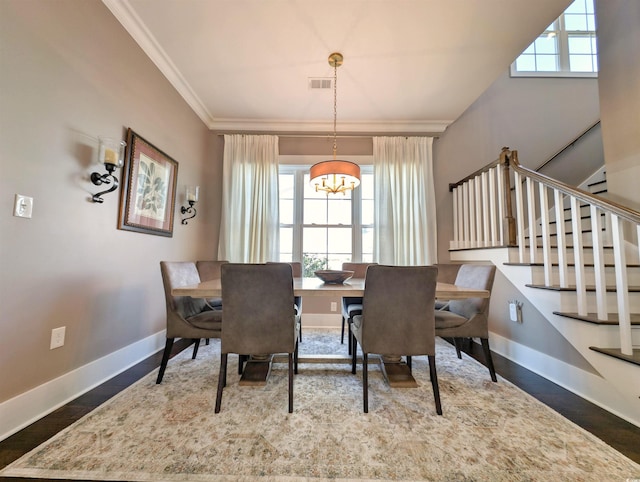 dining room with stairway, baseboards, visible vents, and ornamental molding