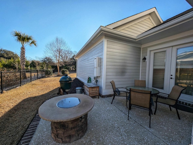 view of patio / terrace featuring a fire pit, outdoor dining area, and fence