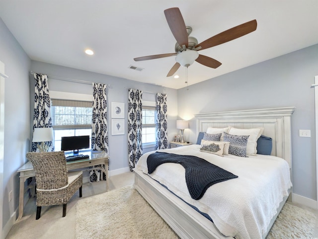 bedroom with visible vents, light carpet, and baseboards