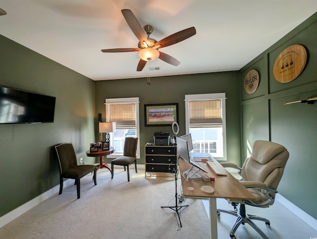 office with light colored carpet, ceiling fan, visible vents, and baseboards