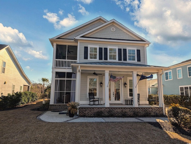 view of front of home featuring a ceiling fan, a sunroom, a porch, and a standing seam roof