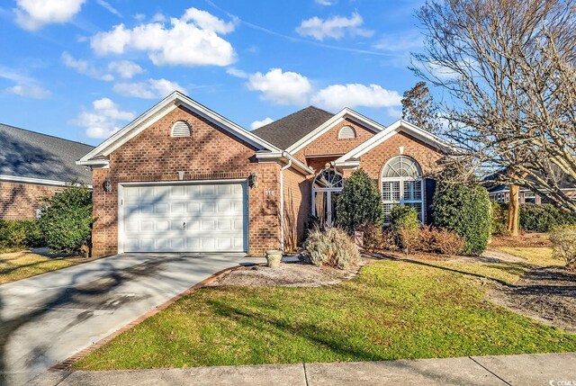 ranch-style home featuring a front lawn, brick siding, driveway, and an attached garage