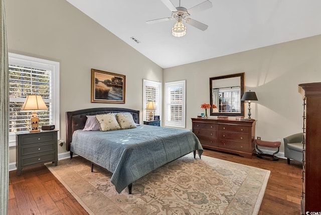 bedroom with visible vents, baseboards, ceiling fan, and dark wood-type flooring