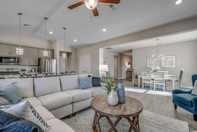 living room featuring ceiling fan with notable chandelier, recessed lighting, baseboards, light wood-type flooring, and visible vents