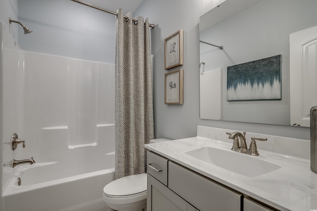 full bath with vanity, shower / tub combo with curtain, and toilet
