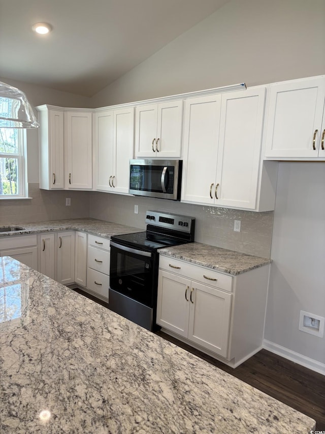 183 Glengrove Ln, Murrells Inlet, SC 29576 - kitchen featuring stainless steel appliances, vaulted ceiling, backsplash, white cabinets, and light stone counters