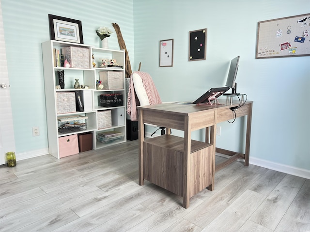 office space featuring light wood-type flooring and baseboards