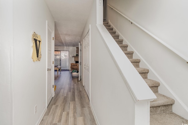 stairs featuring wood finished floors