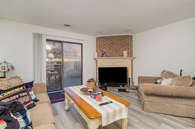 living room featuring visible vents, a textured ceiling, and wood finished floors