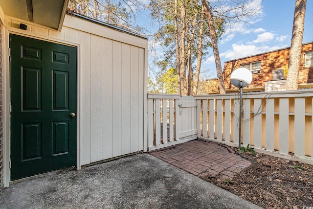 exterior space with a patio, fence, and a gate