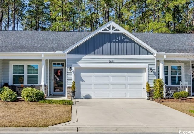 view of front of house featuring driveway, a shingled roof, board and batten siding, and an attached garage