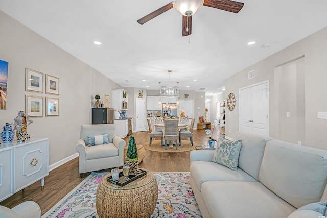 living room with ceiling fan, recessed lighting, wood finished floors, visible vents, and baseboards