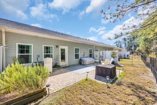 rear view of property featuring a patio and a fenced backyard