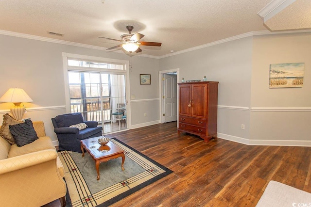 living area with dark wood-style floors, a textured ceiling, visible vents, and crown molding