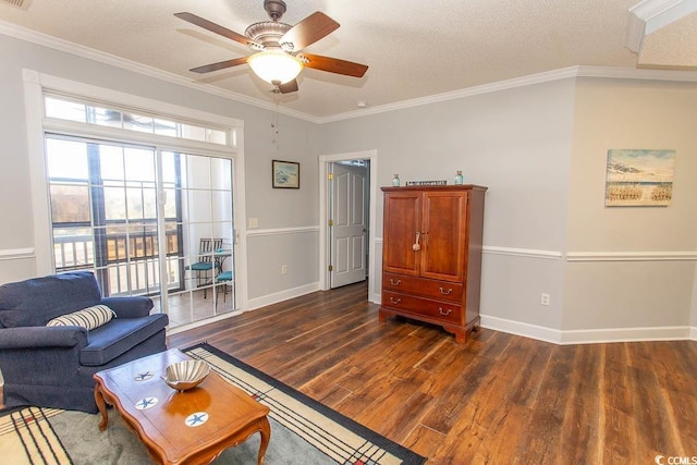 living room featuring crown molding, a textured ceiling, baseboards, and wood finished floors