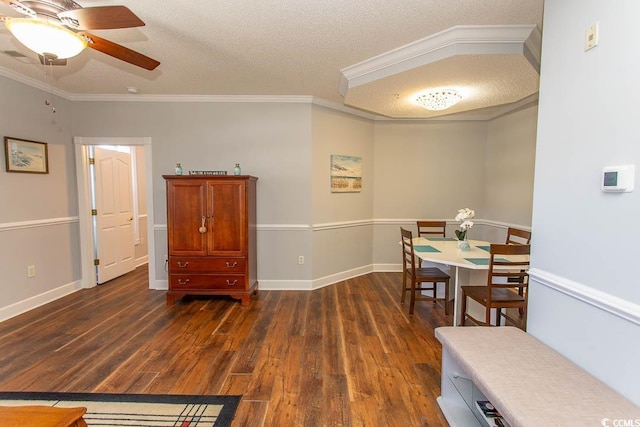 dining room featuring dark wood-style floors, a textured ceiling, baseboards, and crown molding