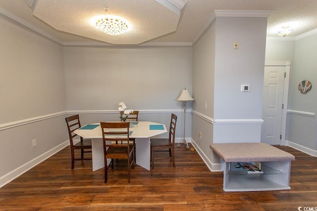 dining space featuring baseboards, a textured ceiling, ornamental molding, and wood finished floors