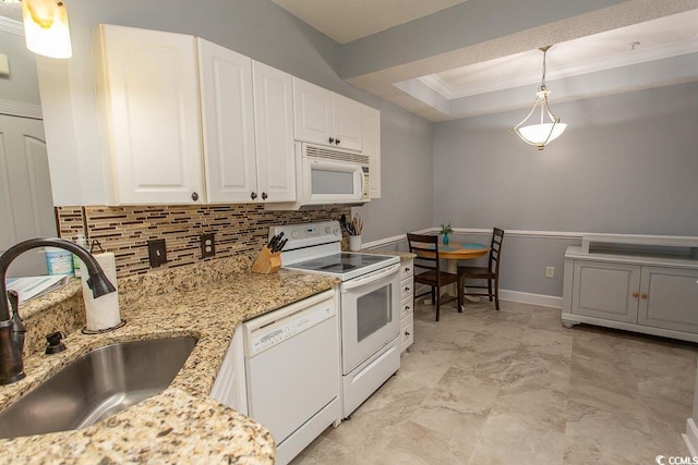 kitchen featuring a tray ceiling, backsplash, white cabinetry, a sink, and white appliances