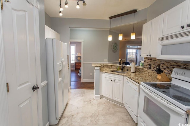 kitchen featuring a peninsula, white appliances, white cabinetry, and a sink