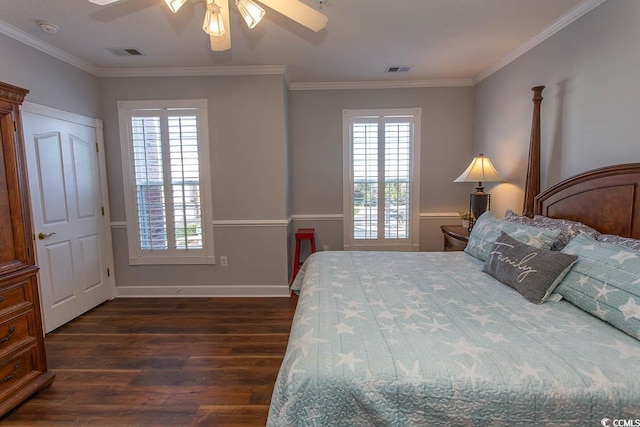 bedroom with multiple windows, visible vents, and dark wood-style flooring