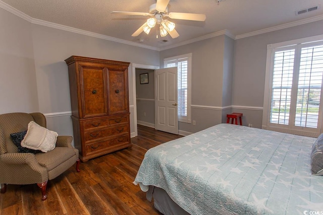 bedroom featuring dark wood-type flooring, multiple windows, visible vents, and crown molding