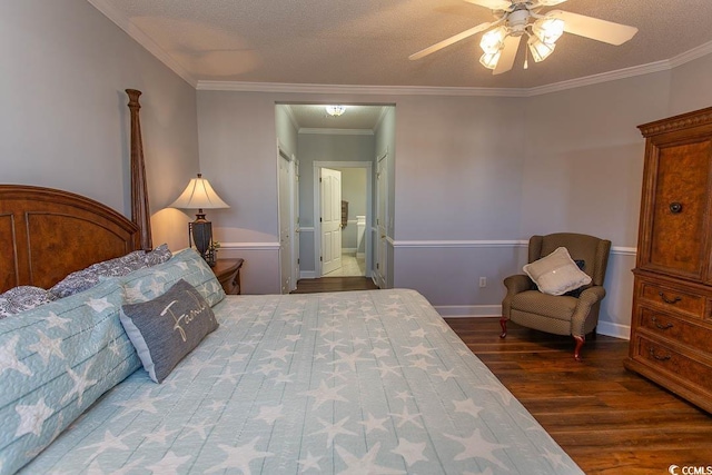 bedroom with a textured ceiling, ornamental molding, wood finished floors, and baseboards