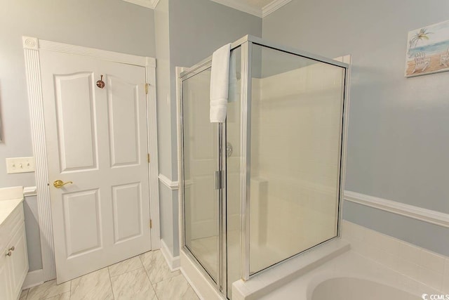 bathroom featuring marble finish floor, a garden tub, crown molding, a stall shower, and vanity