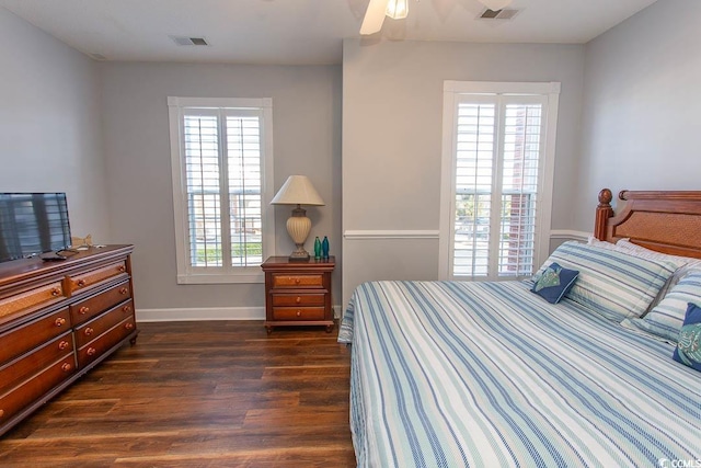 bedroom featuring ceiling fan, baseboards, visible vents, and dark wood finished floors