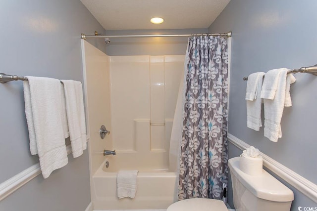 bathroom featuring shower / bath combo and toilet