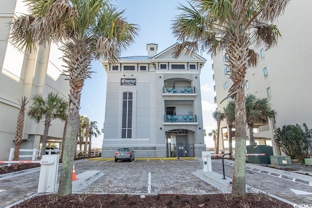 view of building exterior featuring uncovered parking