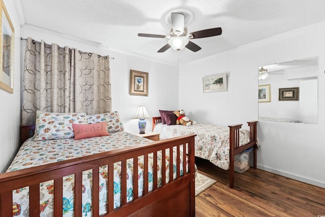 bedroom with ornamental molding, ceiling fan, a textured ceiling, and wood finished floors