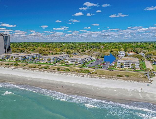 birds eye view of property with a water view and a beach view