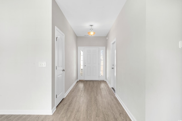 entryway featuring light wood finished floors and baseboards