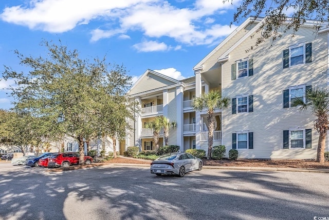 view of property featuring uncovered parking