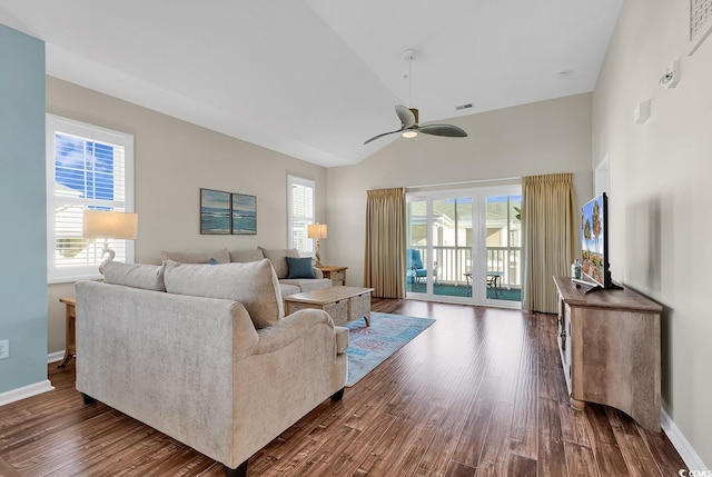 living area featuring baseboards, visible vents, a ceiling fan, dark wood-style flooring, and high vaulted ceiling