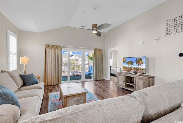 living room with dark wood-style floors, ceiling fan, and high vaulted ceiling