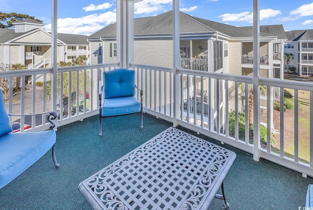 sunroom featuring a residential view