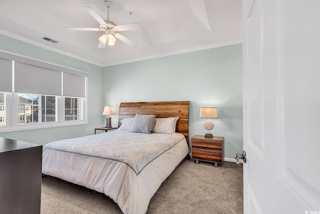 bedroom with baseboards, visible vents, a ceiling fan, light colored carpet, and ornamental molding