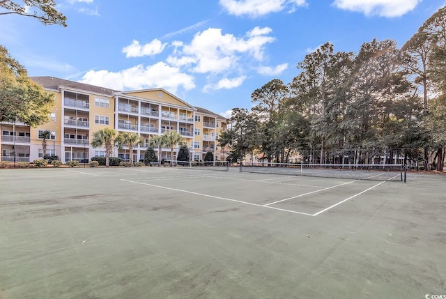 view of tennis court featuring fence