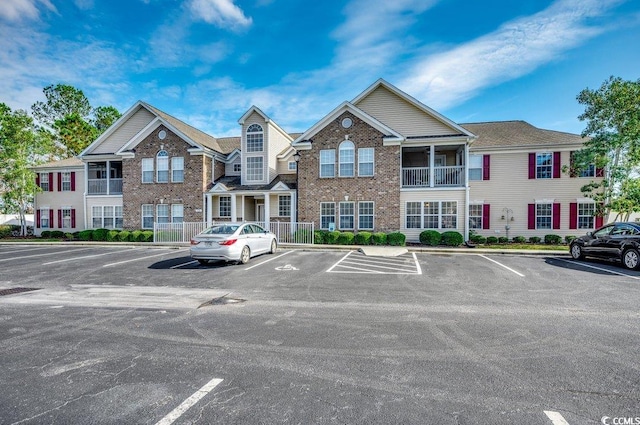 view of building exterior featuring uncovered parking