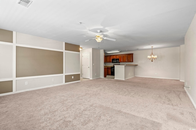 unfurnished living room with ceiling fan with notable chandelier, visible vents, baseboards, and light colored carpet