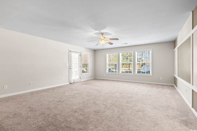 unfurnished room featuring light carpet, ceiling fan, and baseboards