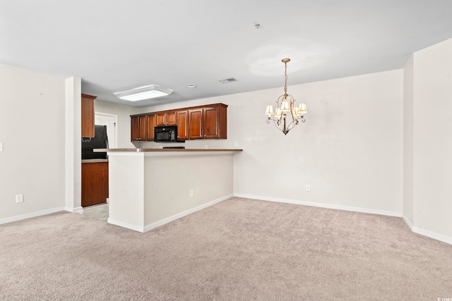 kitchen featuring a peninsula, hanging light fixtures, light countertops, black appliances, and brown cabinetry