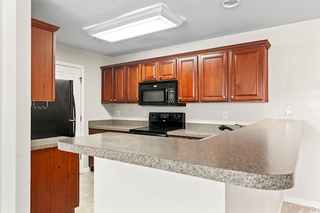 kitchen featuring brown cabinets, a breakfast bar, a peninsula, light countertops, and black appliances