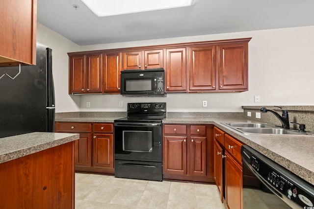 kitchen with dark countertops, black appliances, and a sink