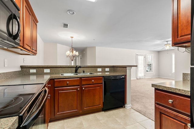 kitchen with visible vents, open floor plan, a sink, black appliances, and ceiling fan with notable chandelier